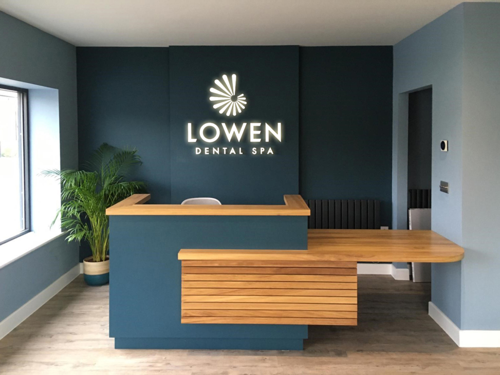 A white LED illumination features on the teal back wall of Lowen Dental Spa