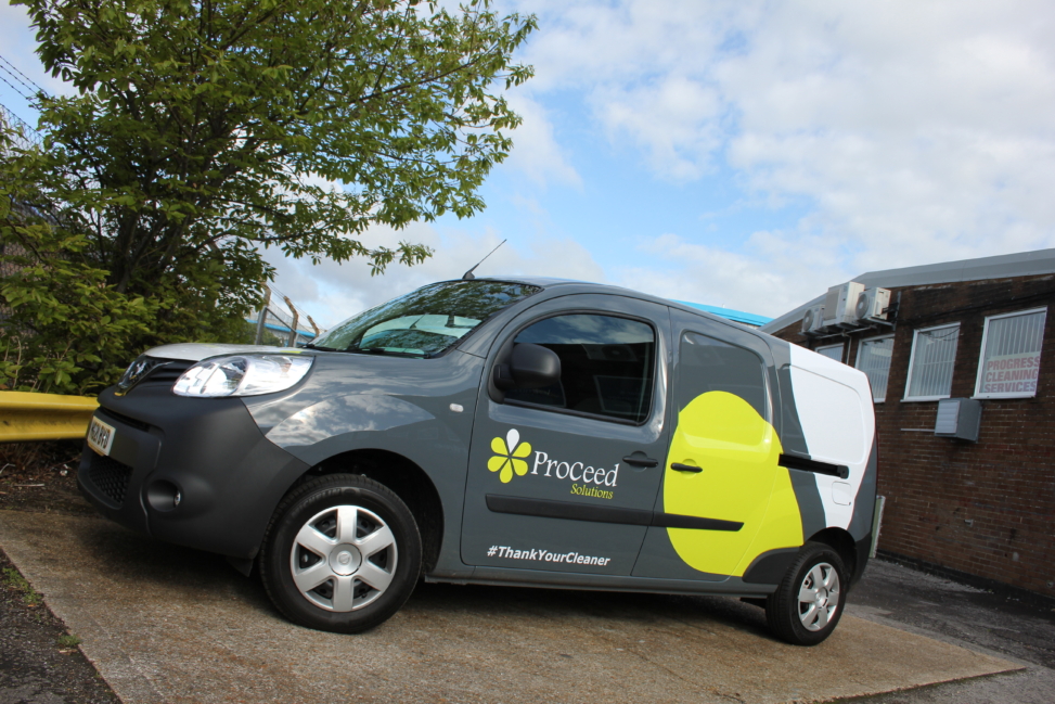 A grey van features a series of print & cut graphics from Elmtree Signs, for the company Proceed Solutions