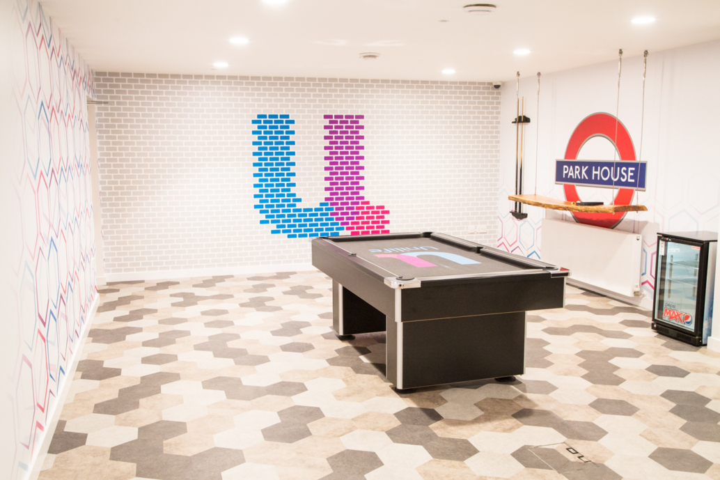 A room at Unilife Winchester features 'U' wall graphics